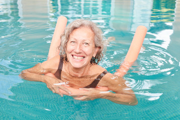 Vital senior woman is learning to swim