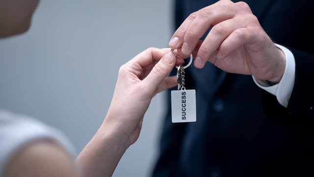 Man giving woman keys to Success, secret tips to turn dream into reality closeup