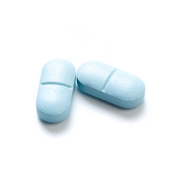 Blue tablets isolated on white background.