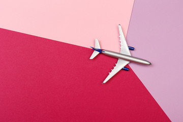 top view photo of toy airplane over color  background . travel concept .