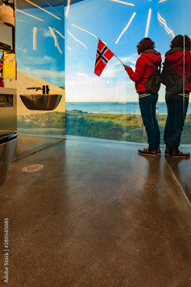 Canvas Prints tourist with norwegian flag in mirrored toilet, andoy norway