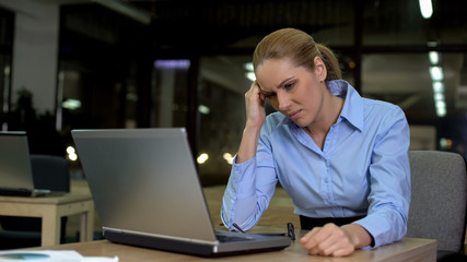 Lady suffering headache, working night shift in office, overworking problem