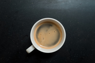 Obraz na płótnie Canvas black coffee on white cup in mini cafe