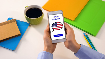 Person holding cellphone with learn English app, foreign language, education