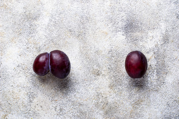 Ugly and normal plums. Abnormal organic fruit