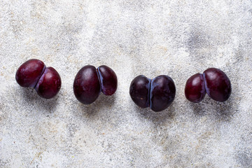 Ugly plums. Abnormal organic fruit