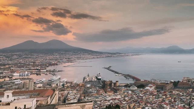 Naples, Italy. Top View Skyline Cityscape In Evening Lighting. Tyrrhenian Sea And Landscape With Volcano Mount Vesuvius. City During Sunset And Night Illuminations. Day To Night Transition