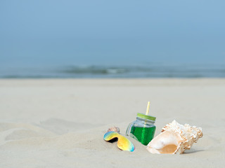 Fresh fruit cocktails on the beach. Summer. Partial focus. Free space.
