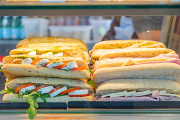 Delicious submarine sandwich with ham cheese and salad at store