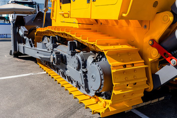 Road construction heavy machinery. Big yellow bulldozer close-up