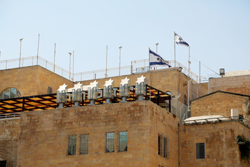 Israel national flag waving on sunny clean sky background
