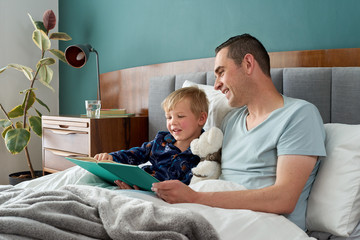 Happy father reading stories with child