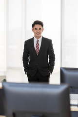 Businessman standing and crossed his arm..