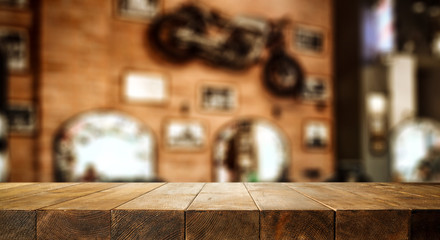 Wooden table background and restaurant interior view. Empty  space for your decoration and an advertising product.