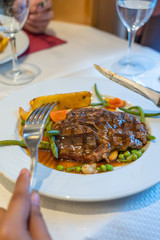 Plate of grilled steak and salad in French restaurant