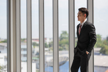 Businessman standing and crossed his arm..