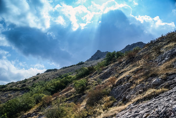  The mountains  with a cloud overhead.Landscape of mountains and rocks. Shadow stone mountain of forest. Green nature of stone mountain