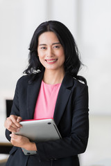 Businesswoman holds tablet computer in her hands..
