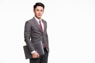 Businessman holding notebook computer.