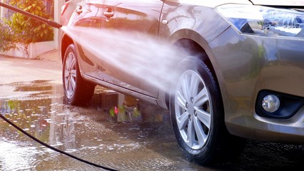 Manual car washing with high pressure water jet at home, self car washing concept 