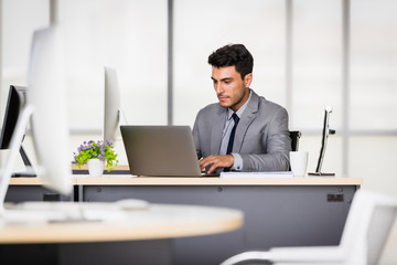 Caucasian businessman holding a pen in his hands..