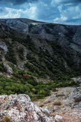  The mountains  with a cloud overhead.Landscape of mountains and rocks. Shadow stone mountain of forest. Green nature of stone mountain