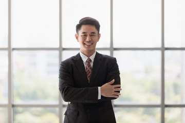 Businessman standing and crossed his arm..