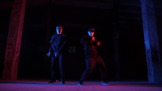 duet of girls dancing hip hop, street dancing in a studio, isolated