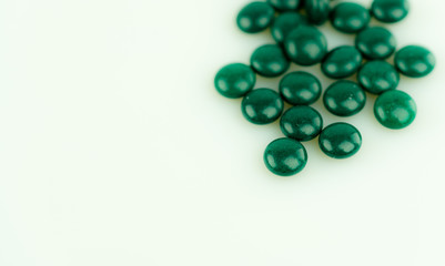 isolated close up of green pills with copy space