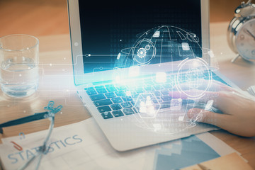 Social network theme hologram with businessman working on computer on background. Concept of world...