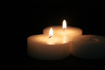 the light of the candle illuminates the darkness