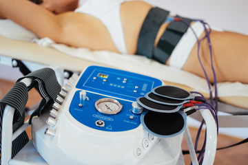 Modern technology medical health and beauty treatment with electrostimulation EMS slimming machine.