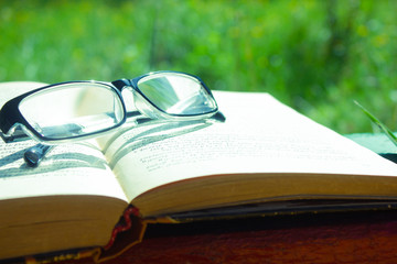 glasses on book on the wooden table