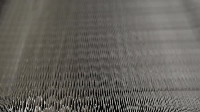 Review of a honeycomb paper laying on the floor. Lowering costs of production. Hexagon tubes pattern. Lighter furniture.