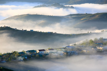dramatic beauty landscape with magic fog and light cover small village in valley at the sunrise, photo used for advertising travel, magazine, printing and more