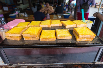 Thailand street food white bread toasted with butter and sugar on the charcoal.