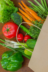 Healthy food in full paper bag of different products, vegetables. Top view. Food background.