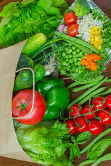 Healthy food in full paper bag of different products, vegetables. Top view. Food background.