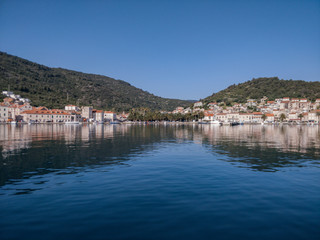 Beautiful seaside village at Croatian coastline shot from boat.