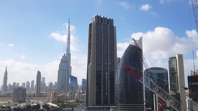 DUBAI, UAE - JUNE 14, 2019: Burj Khalifa. Time lapse of Burj Khalifa over a blue sky and fast moving clouds, view on a sunny day