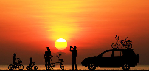 silhouette happy  family  on the beach at  sunrise time