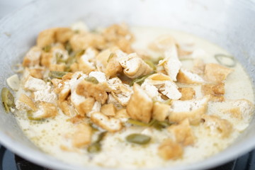 Tofu with coconut sauce and some piece of chili, food