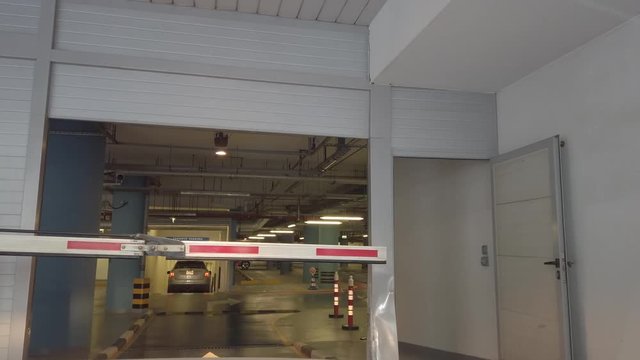 Car entering gated underground parking of a residential - office building