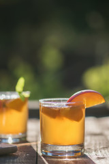 Homemade Fermented Raw Kombucha Tea Ready to Drink With peach. Summer probiotic healthy beverage in glass.