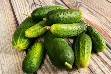 Fresh cucumbers on a wooden table. Autumn harvest thanksgiving Day.