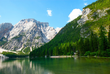 Fototapeta na wymiar Turquoise water of the lake Lago di Braies, Pragser Wildsee surrounded by pine forest and mountains in the Prags Dolomites in South Tyrol, Italy, Europe