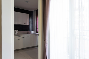 Fototapeta na wymiar Kitchen with white glossy cabinet and drawer