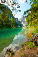 Fototapeta na wymiar Turquoise water of the lake Lago di Braies, Pragser Wildsee surrounded by pine forest and mountains in the Prags Dolomites in South Tyrol, Italy, Europe