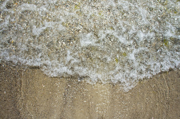 Sea wave on the clean sandy shore of the Black Sea