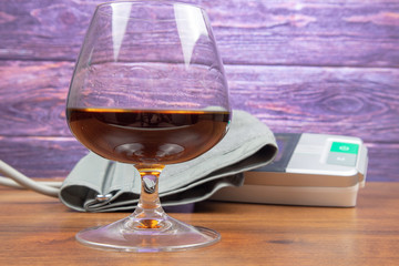 Glass with alcohol and blood pressure monitor